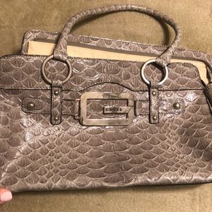 Women’s Guess purse in gray snake finish.